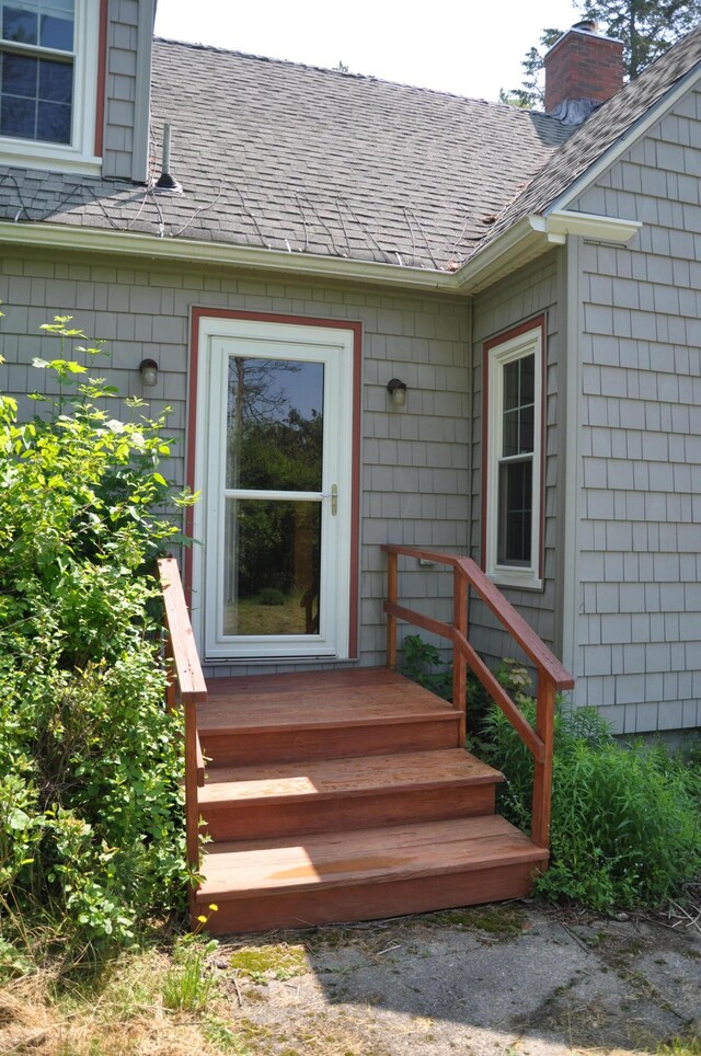 5 Charles St, Orono, ME 04473 - doorway to property with a chimney and roof with shingles
