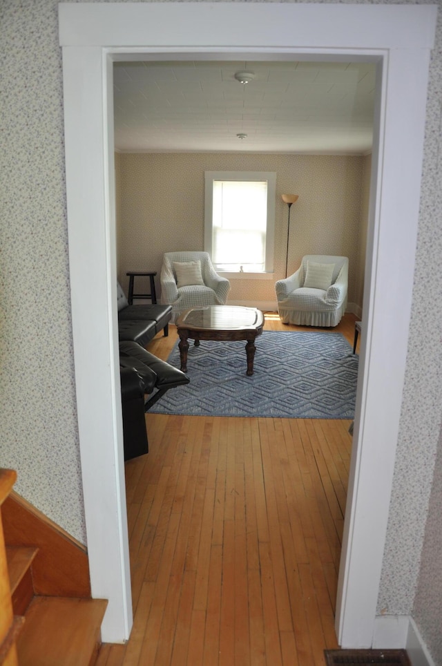 5 Charles St, Orono, ME 04473 - living area with wallpapered walls, wood-type flooring, and stairs