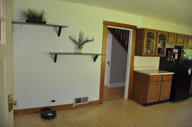 5 Charles St, Orono, ME 04473 - kitchen featuring freestanding refrigerator, glass insert cabinets, brown cabinets, open shelves, and light countertops