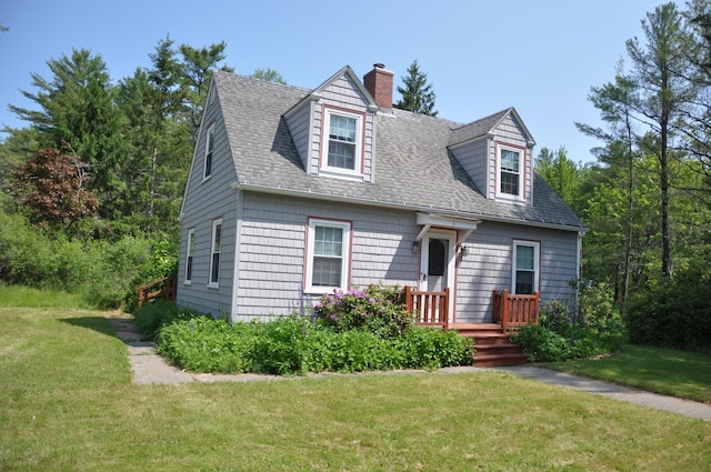 5 Charles St, Orono, ME 04473 - new england style home with a chimney, a front lawn, a shingled roof, and a wooden deck