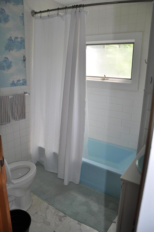 5 Charles St, Orono, ME 04473 - bathroom with toilet, shower / tub combo with curtain, vanity, tile walls, and wainscoting