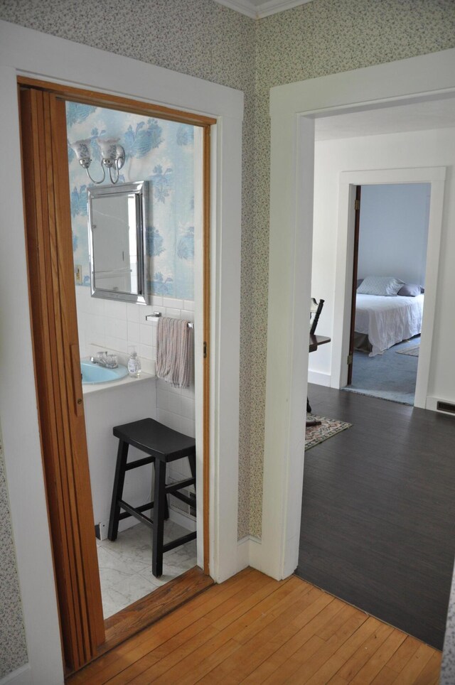 5 Charles St, Orono, ME 04473 - corridor featuring light wood-style flooring, wallpapered walls, and a chandelier