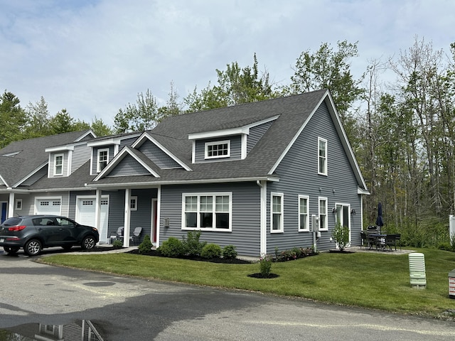 3 Jennifer Ln Unit 1, Wells, ME 04090 - view of front of house featuring a garage, a front lawn, and a shingled roof