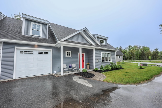 3 Jennifer Ln Unit 1, Wells, ME 04090 - view of front of home with covered porch, a front yard, a shingled roof, and asphalt driveway