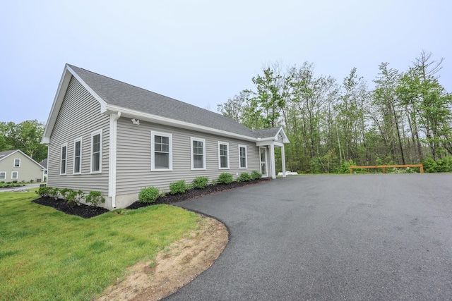 3 Jennifer Ln Unit 1, Wells, ME 04090 - view of side of home with a lawn, asphalt driveway, and a shingled roof