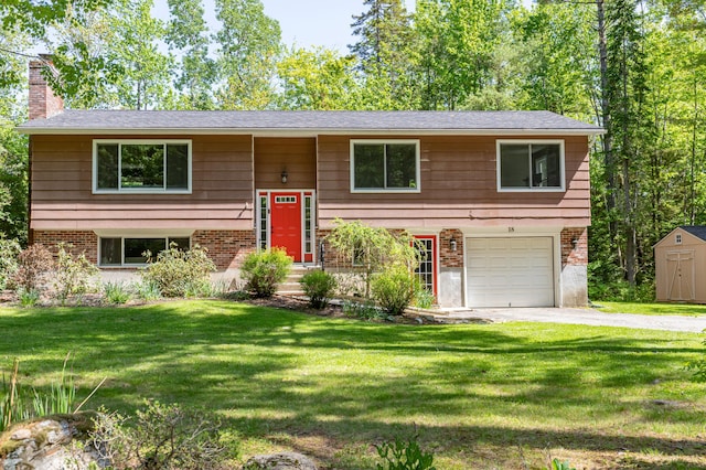 18 Brian Dr, Brewer, ME 04412 - bi-level home featuring a garage, driveway, a chimney, and brick siding
