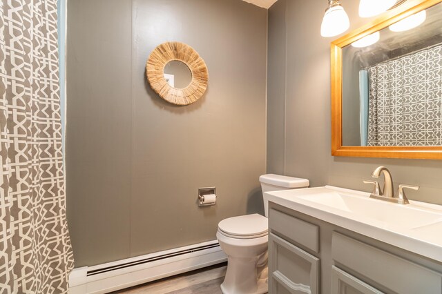 18 Brian Dr, Brewer, ME 04412 - full bathroom with baseboard heating, toilet, vanity, a shower with curtain, and wood finished floors