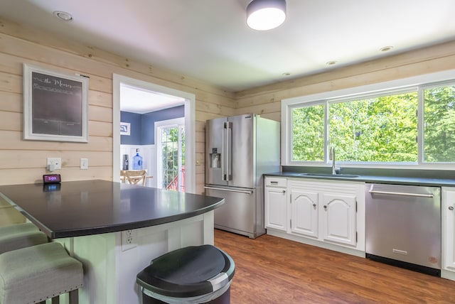 18 Brian Dr, Brewer, ME 04412 - kitchen featuring appliances with stainless steel finishes, a sink, dark countertops, a peninsula, and a kitchen bar