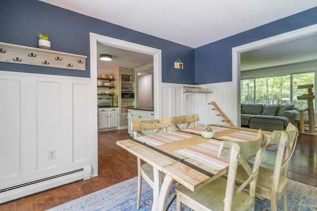 18 Brian Dr, Brewer, ME 04412 - dining space featuring a baseboard radiator, a decorative wall, a wainscoted wall, and dark wood-style floors