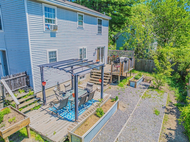 10 Empire Way, Portland, ME 04103 - back of house featuring a vegetable garden, a wooden deck, a fenced backyard, and a pergola