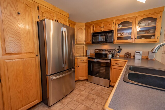 52 Judkins Rd, Harmony, ME 04942 - kitchen featuring stainless steel appliances, a sink, glass insert cabinets, and light countertops