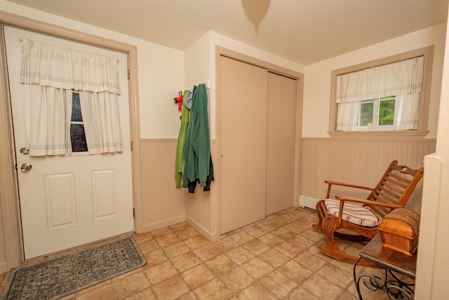 52 Judkins Rd, Harmony, ME 04942 - entrance foyer with a wainscoted wall, stone finish flooring, and a baseboard radiator