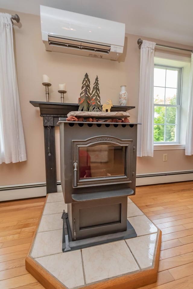 52 Judkins Rd, Harmony, ME 04942 - detailed view of a baseboard radiator, an AC wall unit, and wood finished floors