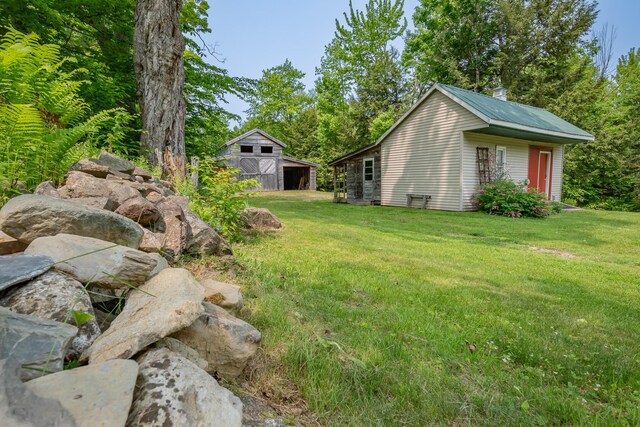 52 Judkins Rd, Harmony, ME 04942 - view of grassy yard with an outdoor structure and a garage