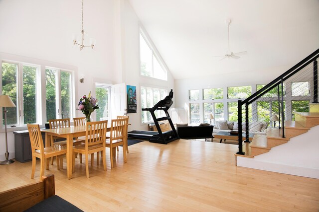 2301 State Route 129, South Bristol, ME 04568 - dining area with high vaulted ceiling, wood finished floors, stairway, a chandelier, and a ceiling fan