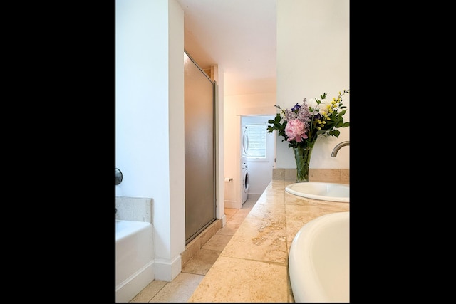2301 State Route 129, South Bristol, ME 04568 - bathroom with a stall shower, a garden tub, washer / clothes dryer, and tile patterned floors