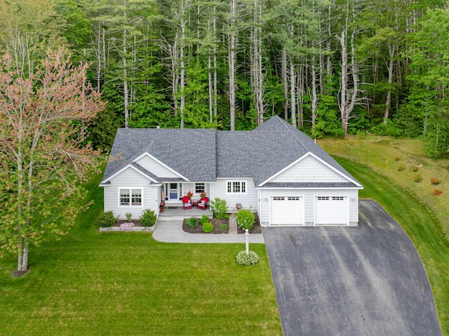 2 Neptune Rd, Old Orchard Beach, ME 04064 - view of front facade with an attached garage, driveway, a front lawn, and a shingled roof