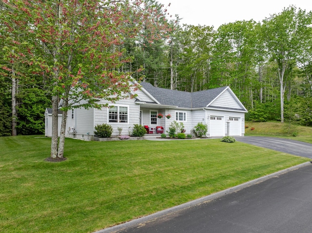 2 Neptune Rd, Old Orchard Beach, ME 04064 - view of front of house with asphalt driveway, an attached garage, a front lawn, and a shingled roof