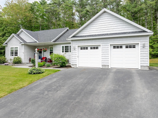 2 Neptune Rd, Old Orchard Beach, ME 04064 - single story home featuring asphalt driveway, a front yard, a garage, a porch, and roof with shingles