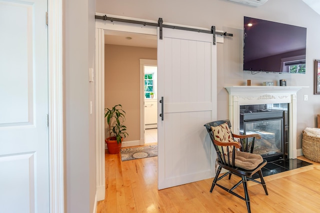 2 Neptune Rd, Old Orchard Beach, ME 04064 - sitting room featuring hardwood / wood-style flooring, a glass covered fireplace, plenty of natural light, and baseboards
