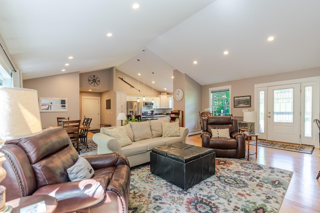 2 Neptune Rd, Old Orchard Beach, ME 04064 - living room featuring recessed lighting, light wood finished floors, a baseboard heating unit, and high vaulted ceiling
