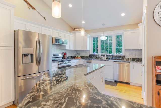 2 Neptune Rd, Old Orchard Beach, ME 04064 - kitchen featuring appliances with stainless steel finishes, white cabinetry, tasteful backsplash, lofted ceiling, and recessed lighting