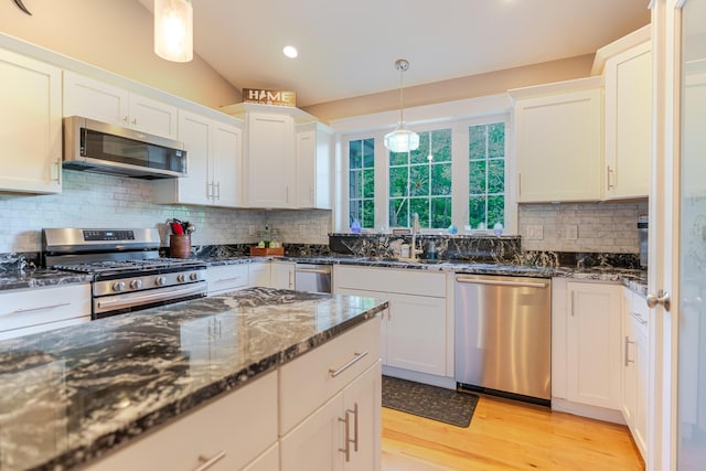 2 Neptune Rd, Old Orchard Beach, ME 04064 - kitchen featuring stainless steel appliances, a sink, light wood-style floors, backsplash, and white cabinets
