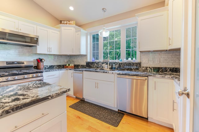 2 Neptune Rd, Old Orchard Beach, ME 04064 - kitchen featuring appliances with stainless steel finishes, light wood-type flooring, white cabinets, tasteful backsplash, and recessed lighting