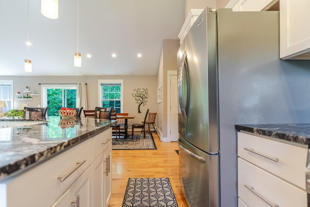 2 Neptune Rd, Old Orchard Beach, ME 04064 - kitchen featuring freestanding refrigerator, white cabinetry, light wood-style floors, pendant lighting, and dark stone counters