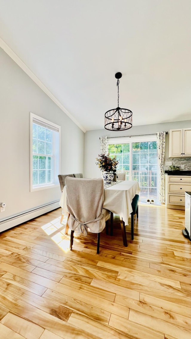 40 Ellis Ct, Bangor, ME 04401 - dining space featuring a chandelier, lofted ceiling, crown molding, light wood finished floors, and a baseboard radiator
