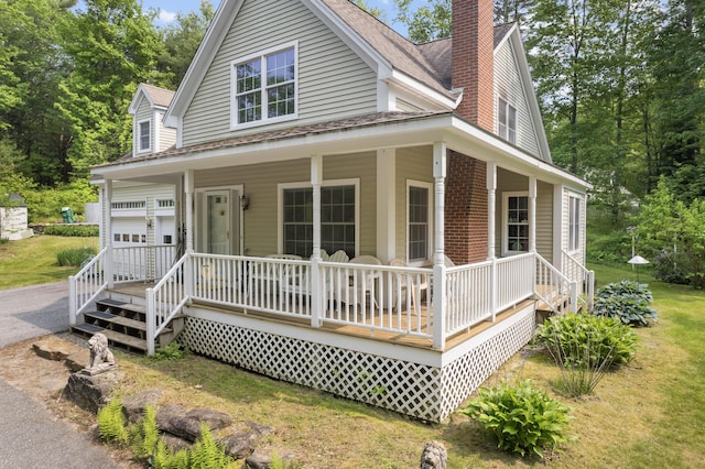 30 Oliver Woods Rd, Nobleboro, ME 04555 - country-style home with a porch, a chimney, and roof with shingles