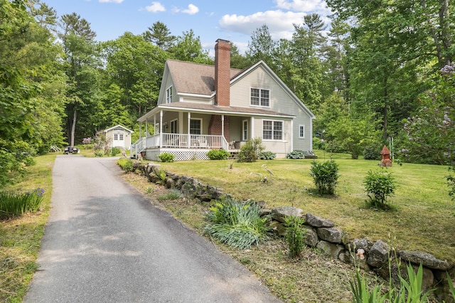 30 Oliver Woods Rd, Nobleboro, ME 04555 - country-style home with covered porch, a chimney, and a front lawn