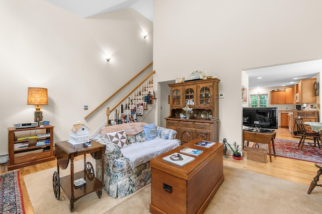 30 Oliver Woods Rd, Nobleboro, ME 04555 - living area featuring high vaulted ceiling, stairway, and light wood-type flooring