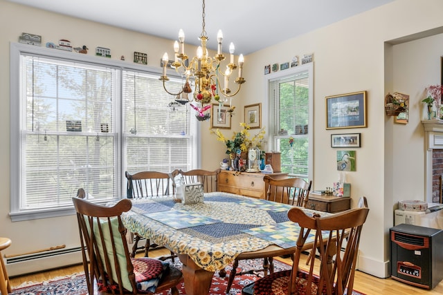 30 Oliver Woods Rd, Nobleboro, ME 04555 - dining area featuring light wood-style floors, a chandelier, a baseboard heating unit, and baseboards