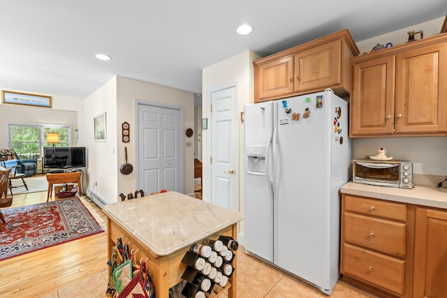 30 Oliver Woods Rd, Nobleboro, ME 04555 - kitchen with white fridge with ice dispenser, a baseboard radiator, light countertops, recessed lighting, and open floor plan