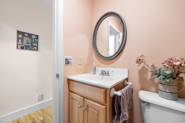 30 Oliver Woods Rd, Nobleboro, ME 04555 - bathroom with toilet, vanity, wood finished floors, and baseboards