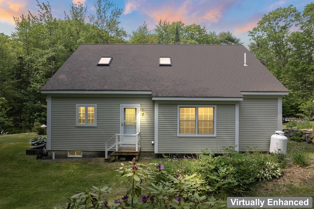 30 Oliver Woods Rd, Nobleboro, ME 04555 - back of property at dusk featuring roof with shingles and a yard