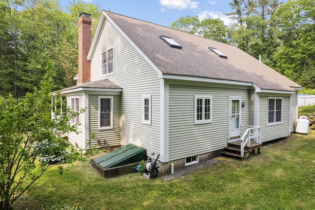 30 Oliver Woods Rd, Nobleboro, ME 04555 - back of house featuring a chimney, roof with shingles, and a lawn