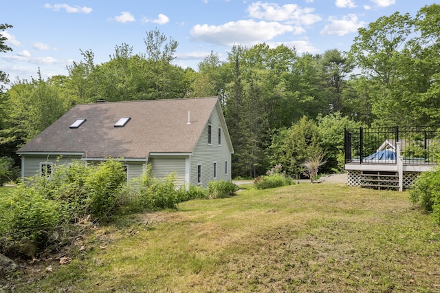 30 Oliver Woods Rd, Nobleboro, ME 04555 - view of side of property featuring a deck, a lawn, roof with shingles, and a view of trees