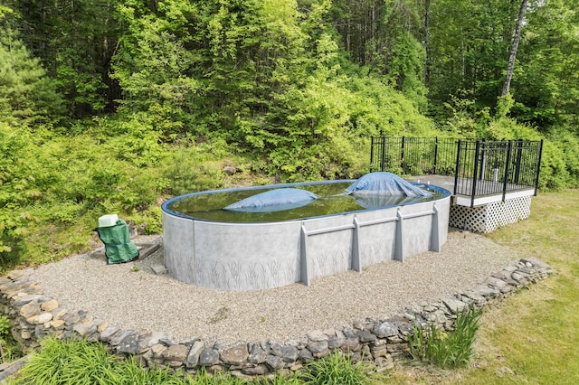 30 Oliver Woods Rd, Nobleboro, ME 04555 - view of swimming pool with a deck and a wooded view