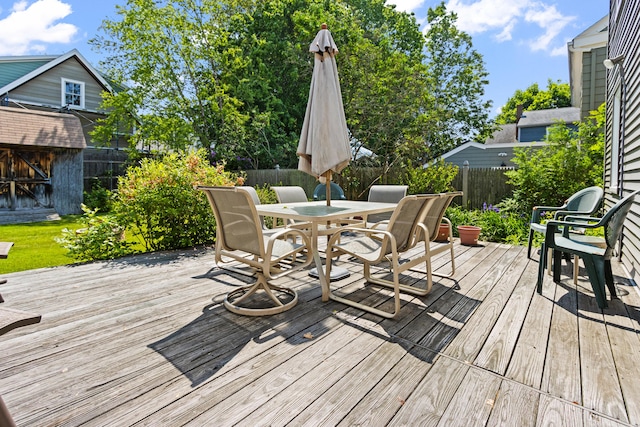 194 Margaret St, South Portland, ME 04106 - deck featuring outdoor dining space, a fenced backyard, and a storage unit