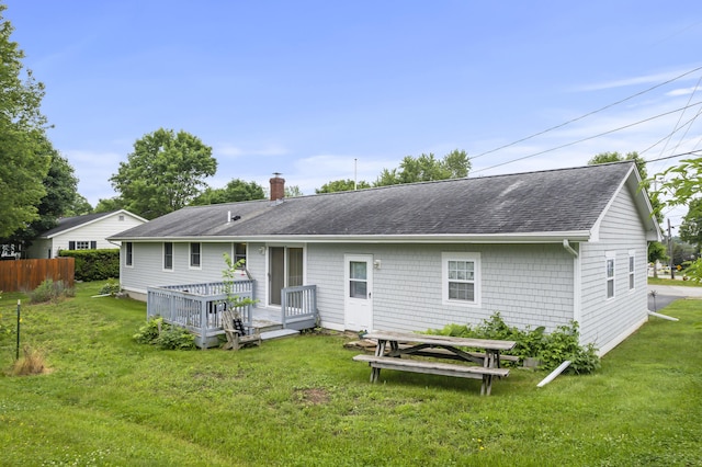 2 Laase Ave, Lewiston, ME 04240 - rear view of property featuring roof with shingles, a chimney, a lawn, and a deck