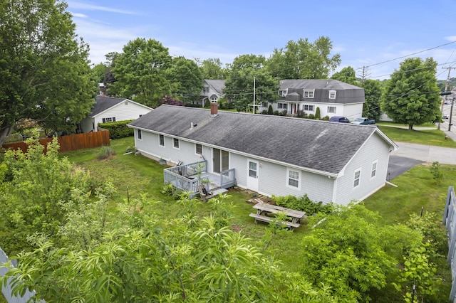 2 Laase Ave, Lewiston, ME 04240 - rear view of property featuring a shingled roof, a chimney, a deck, and view of wooded area