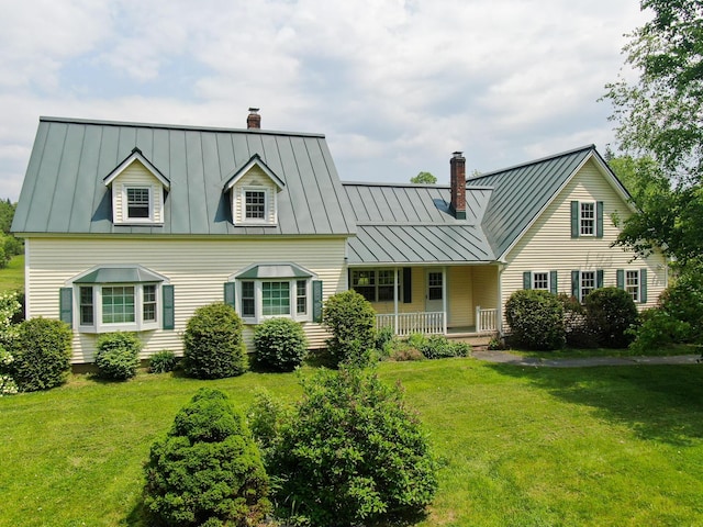 124 Swan Rd, Hermon, ME 04401 - cape cod home with a standing seam roof, a chimney, a front lawn, and metal roof