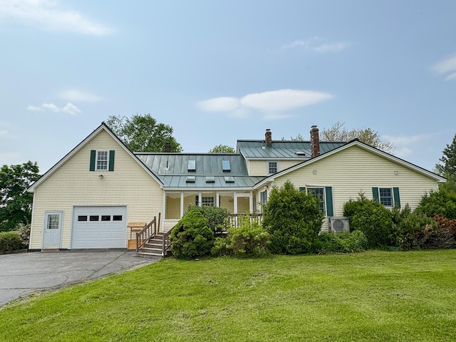 124 Swan Rd, Hermon, ME 04401 - traditional-style home featuring a chimney, a porch, asphalt driveway, a standing seam roof, and a front lawn