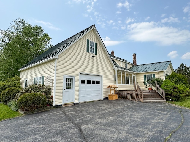 124 Swan Rd, Hermon, ME 04401 - view of front of property with a chimney, metal roof, driveway, and a standing seam roof