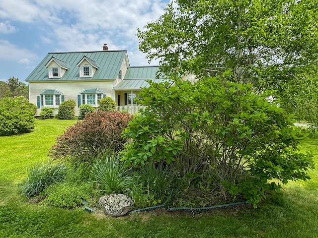 124 Swan Rd, Hermon, ME 04401 - view of front of house featuring a standing seam roof, a chimney, a front lawn, and metal roof