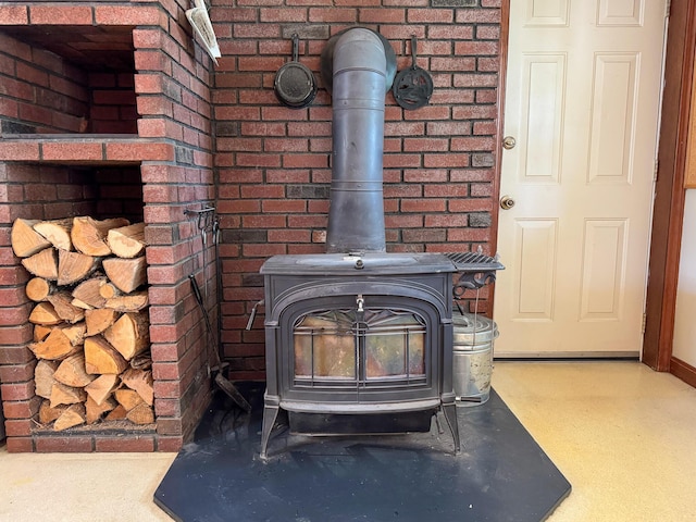 124 Swan Rd, Hermon, ME 04401 - detailed view of a wood stove, baseboards, and brick wall