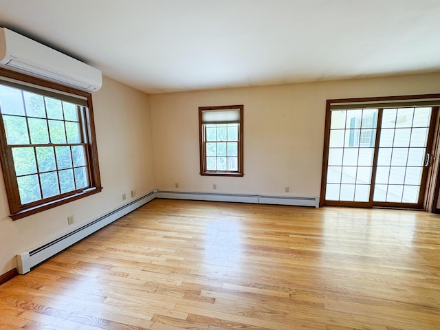 124 Swan Rd, Hermon, ME 04401 - unfurnished room with an AC wall unit, a baseboard radiator, light wood-type flooring, and baseboards