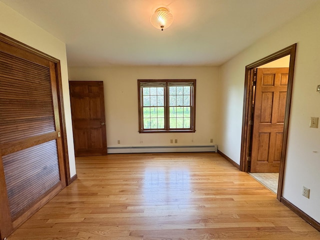 124 Swan Rd, Hermon, ME 04401 - unfurnished bedroom with a baseboard heating unit, light wood-type flooring, and baseboards